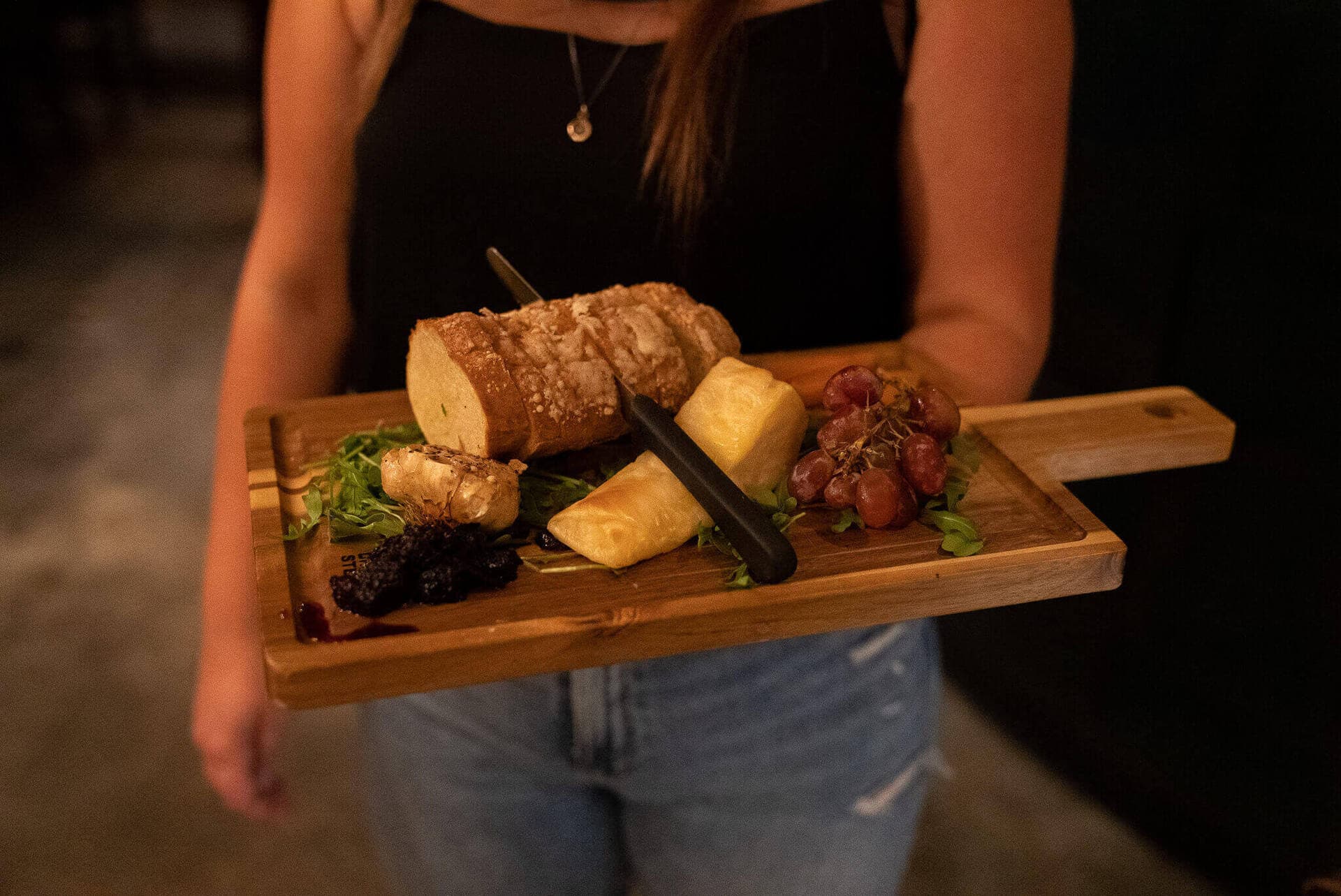 A served charcuterie and cheese board at Cenote